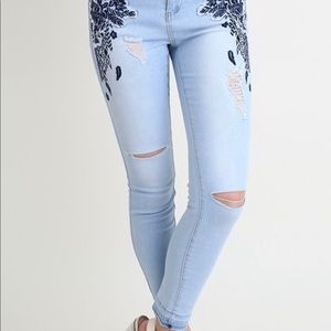 Floral embroidered light blue skinny jeans.